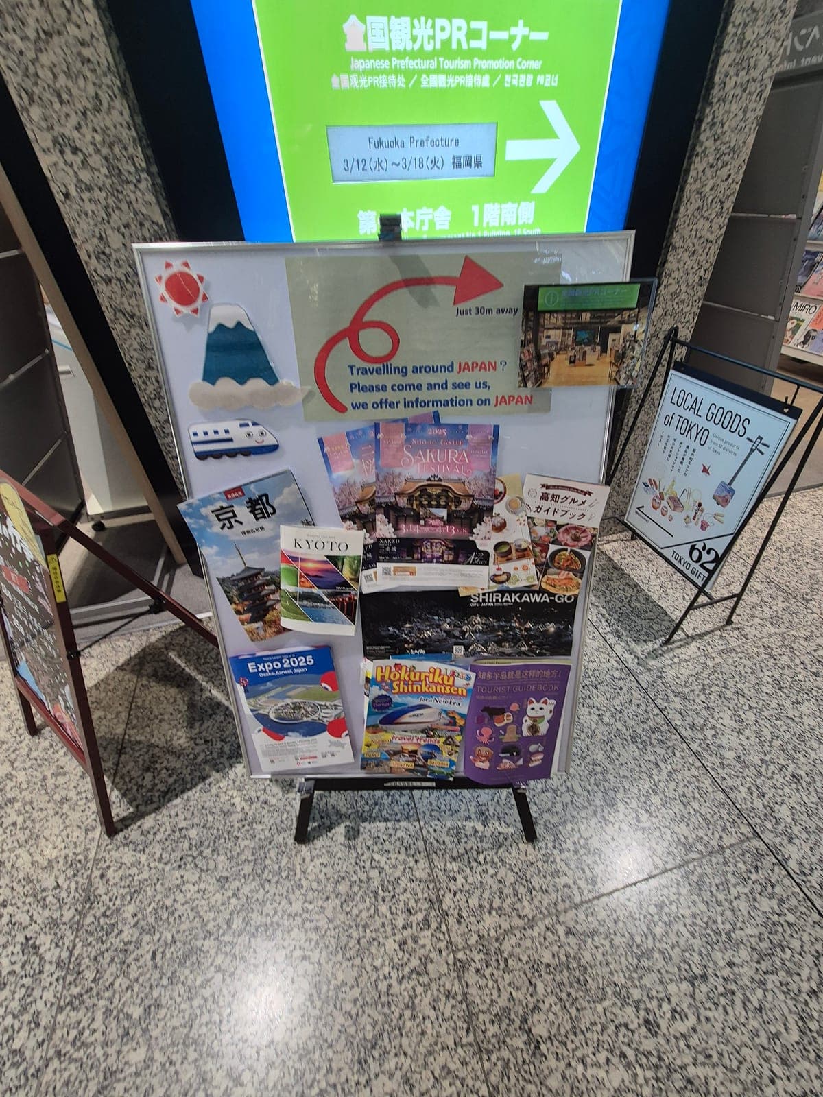 Puesto de promoción turística dentro del mirador del Gobierno Metropolitano, con folletos de destinos de Japón y una decoración del monte Fuji