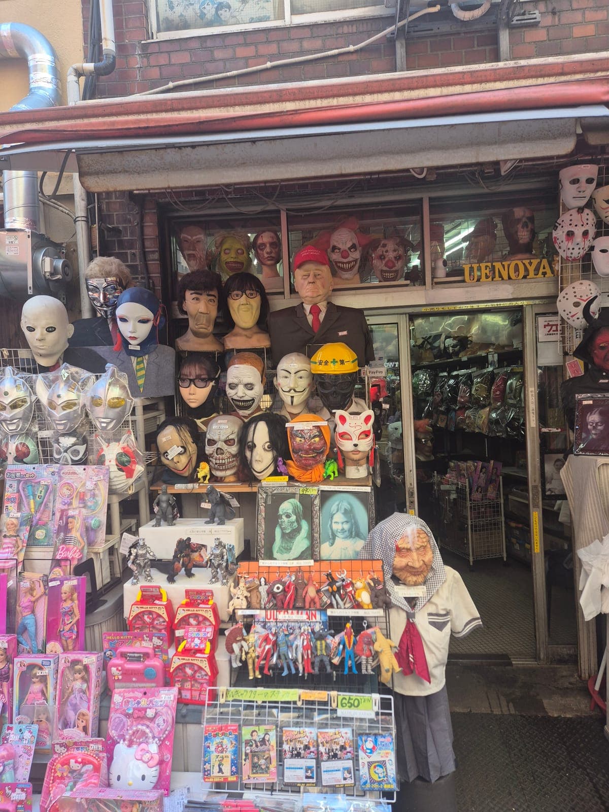 Fachada de la tienda Uenoya en Ameyoko, con docenas de máscaras de disfraz exhibidas, desde payasos hasta personajes de anime